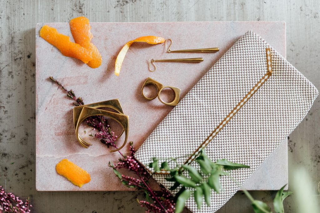 Ethical jewelry by Soko flatlay with vintage clutch
