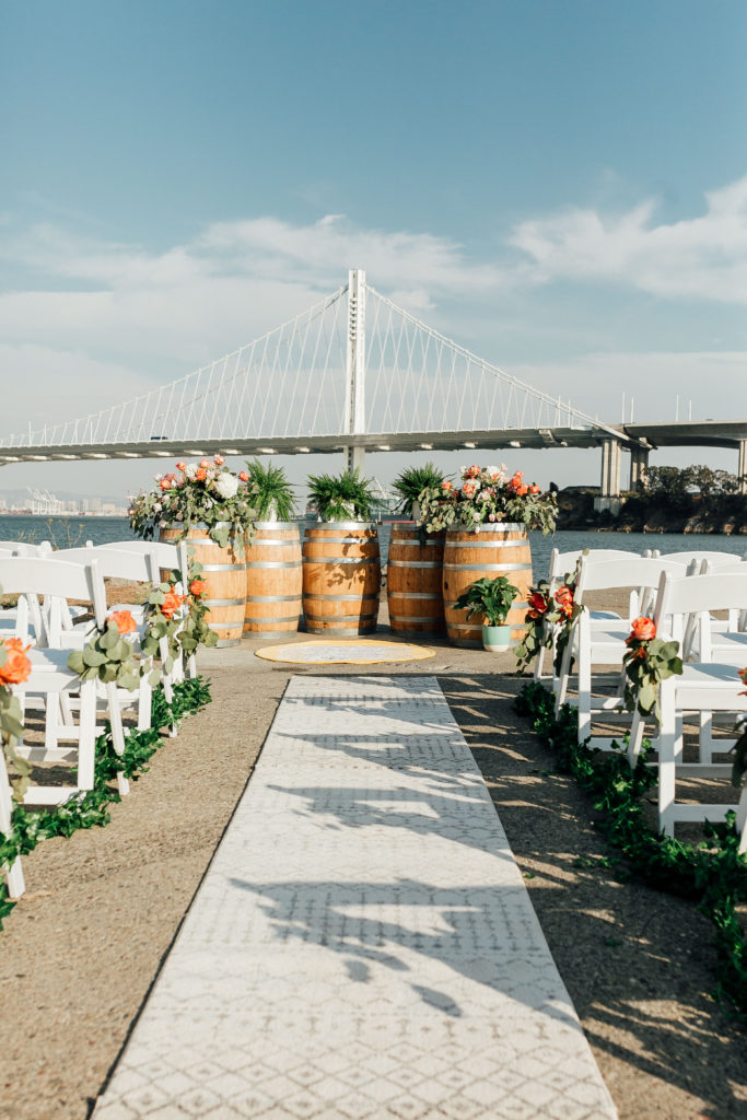 Modern ceremony setup in front of the Bay Bridge at Treasure Island