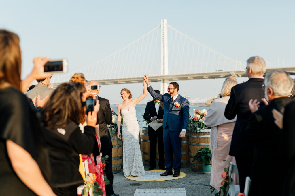 Bride and Groom on Treasure Island with the Bay Bridge in the background - they did it!