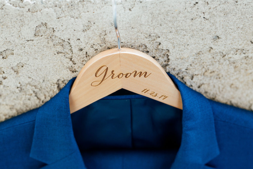 detail of groom's jacket and custom hanger