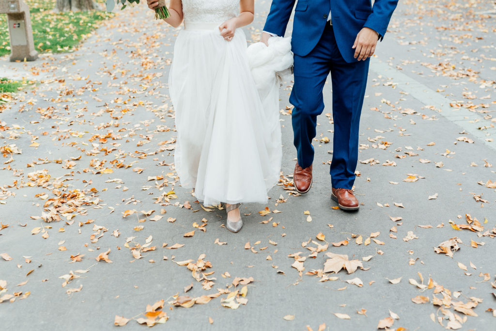 bottom half of bride and groom walking