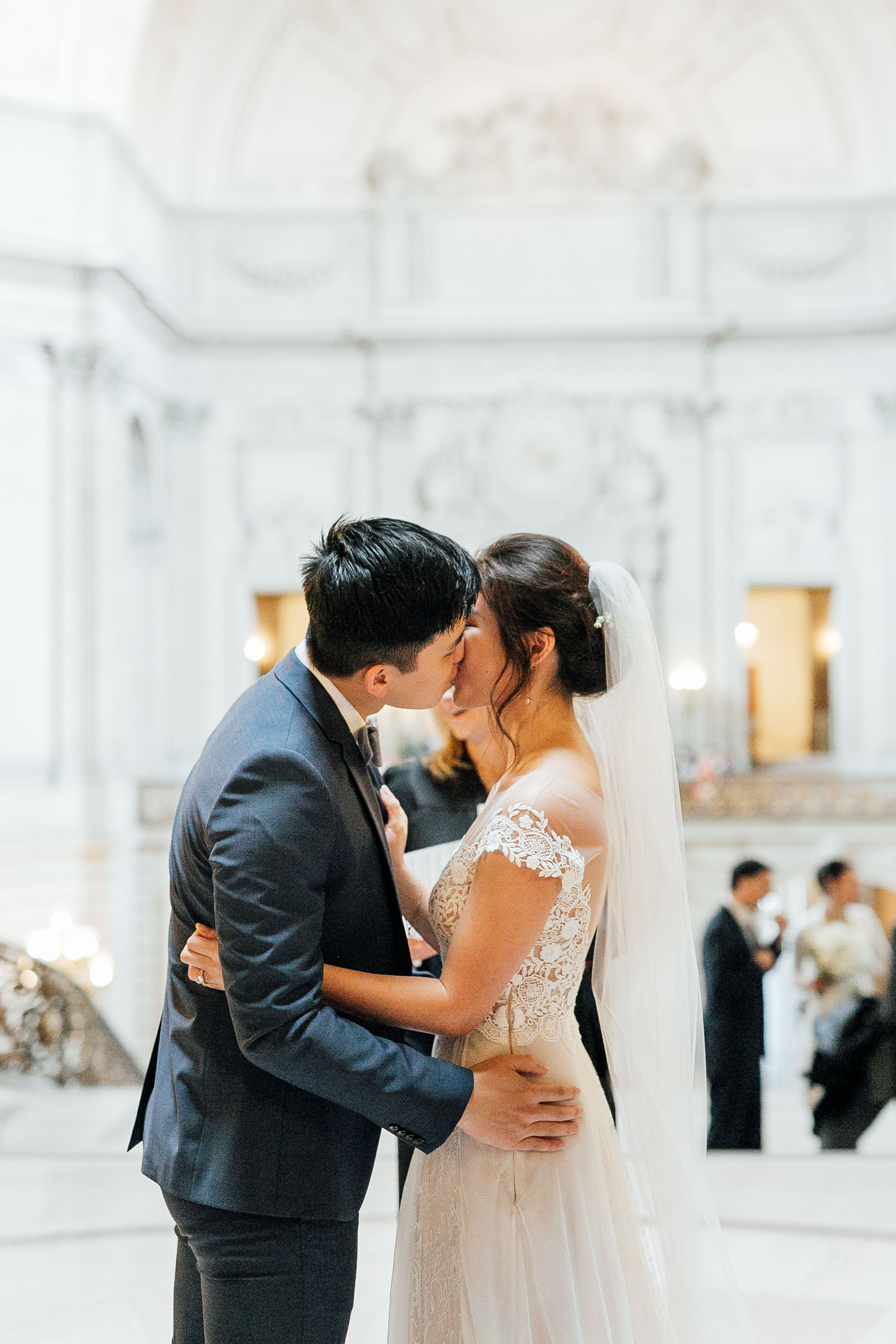 Groom kisses bride during ceremony