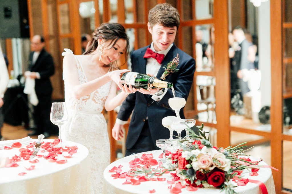 Bride and groom pour champagne into glasses