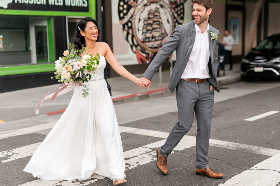 John and Sharon walk across the street hand in hand toward their San Francisco ethical wedding at Stable Cafe.