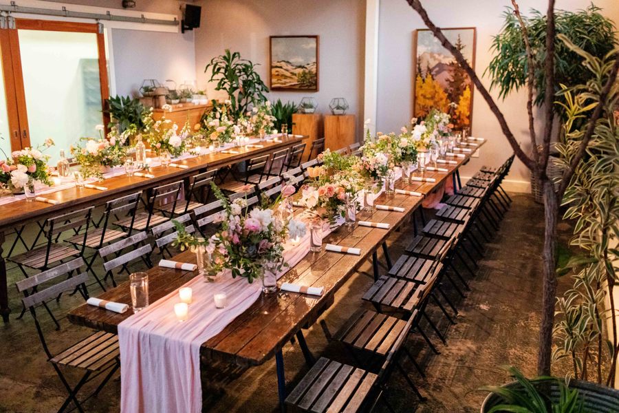 The gorgeous and natural interior of this eco friendly wedding included sustainable wedding flowers and palm leaf plates.