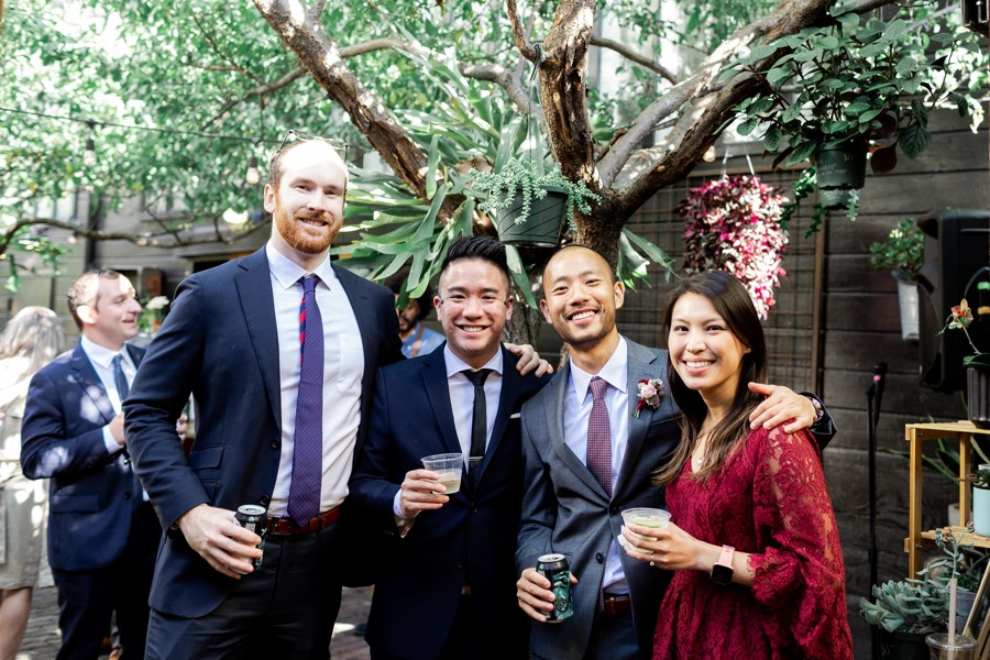 Wedding guests pose for a picture at an outdoor wedding ceremony in San Francisco, CA.