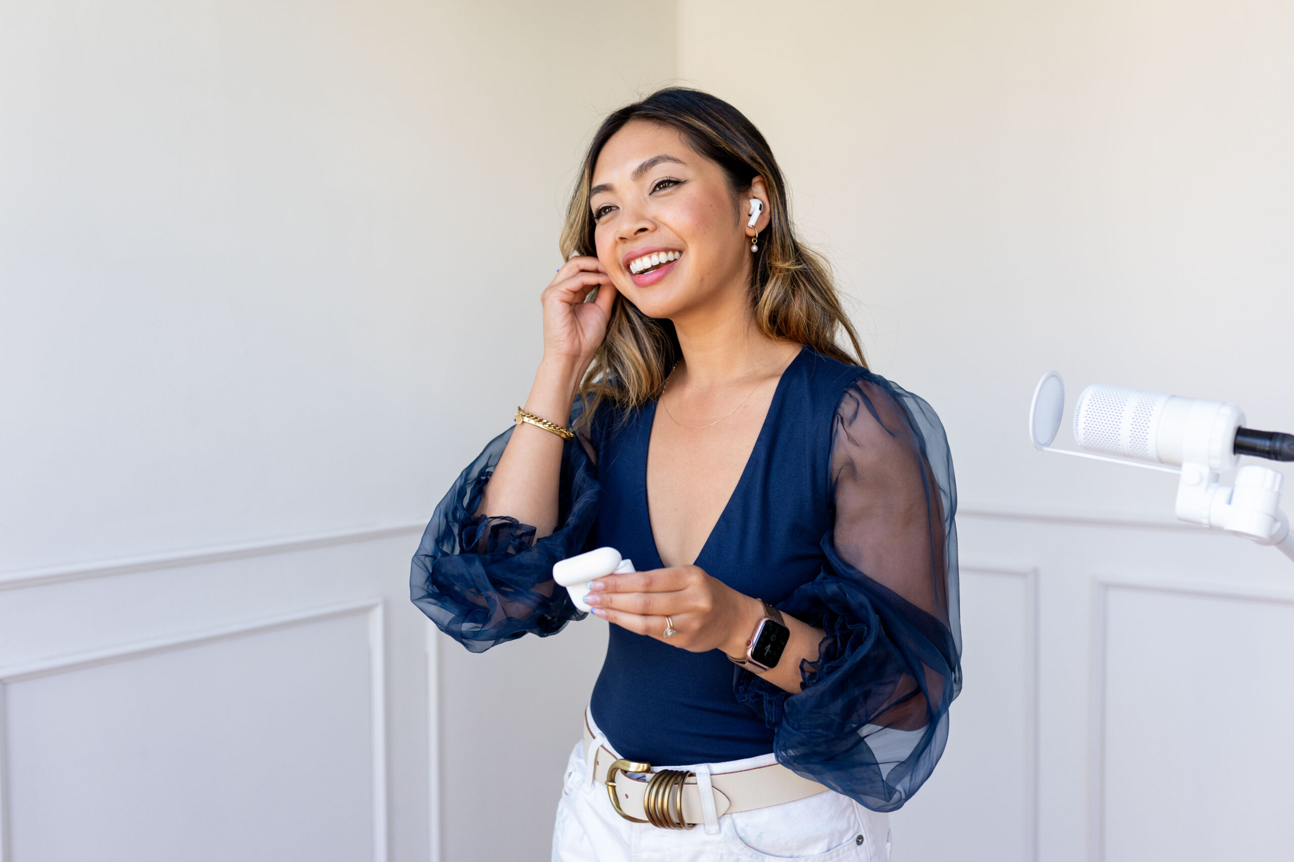 Branding Your Business podcast Host Praise Santos McKenna putting in headphones